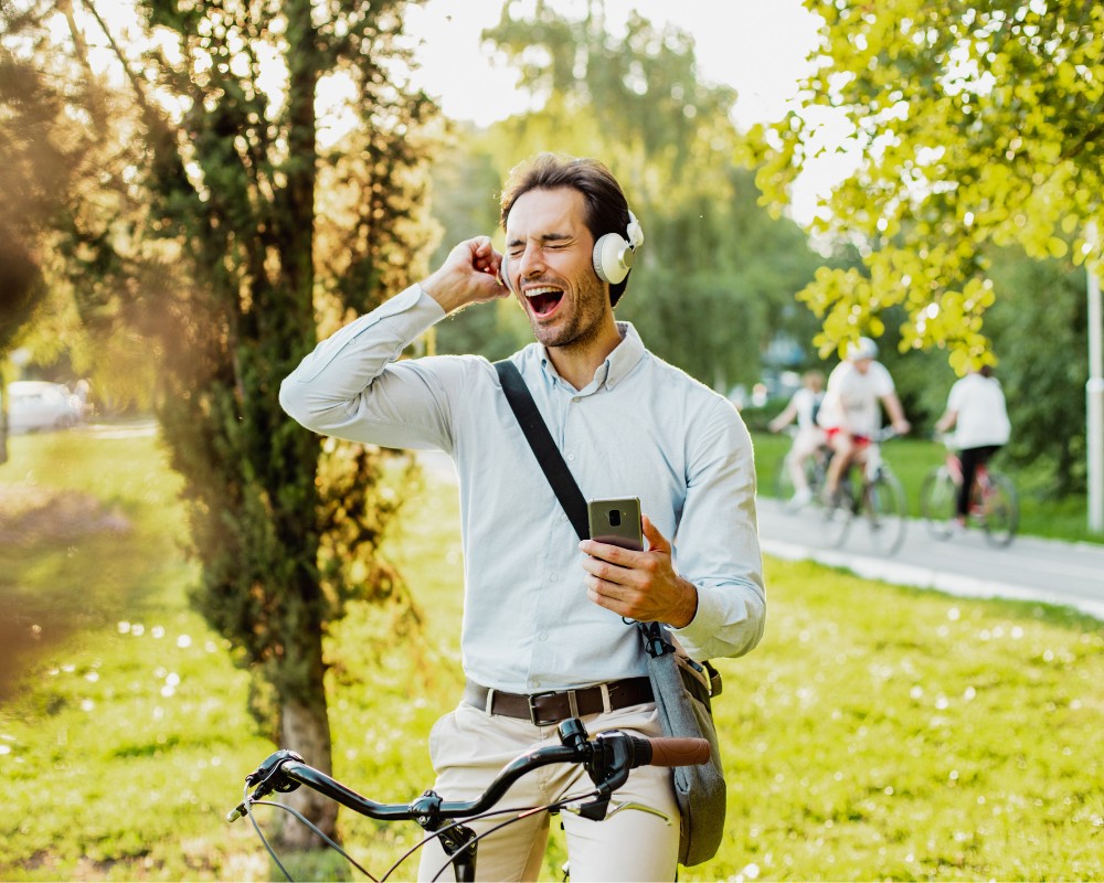 A man listening song on the headphones in the park