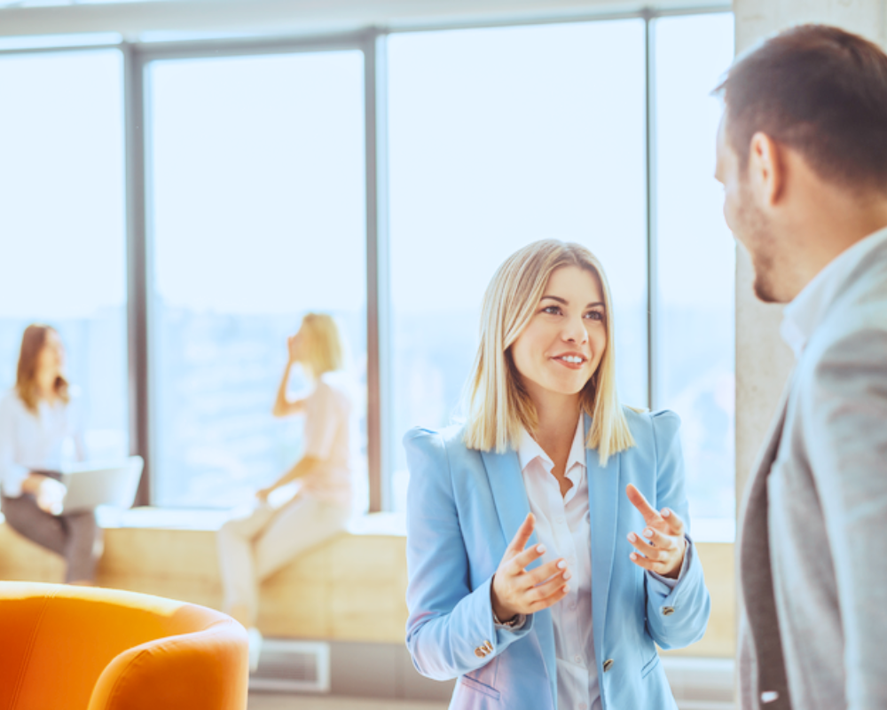 Two people talking to each other in office